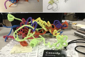 several piles of many colorful pipe cleaners, all connected together during a design thinking workshop facilitated by Cassidy C Browning