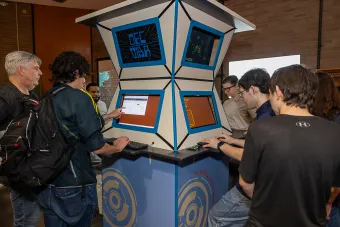 AET students play a game in a display with an Armadillo World Headquarters-inspired design