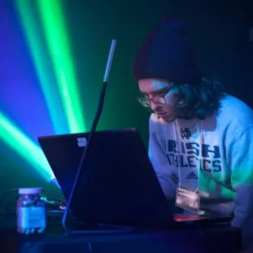 a student standing at a VJ lighting booth