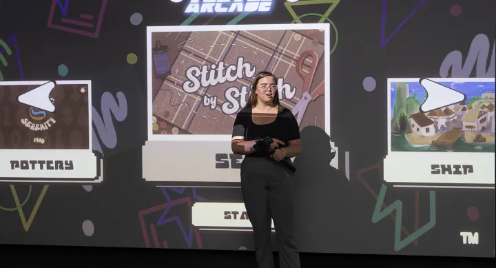 AET student Ella Gault presents about her game onstage